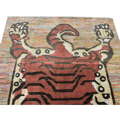 254 - FINE TIBETAN TIGER CARPET, 227cm x 173cm.