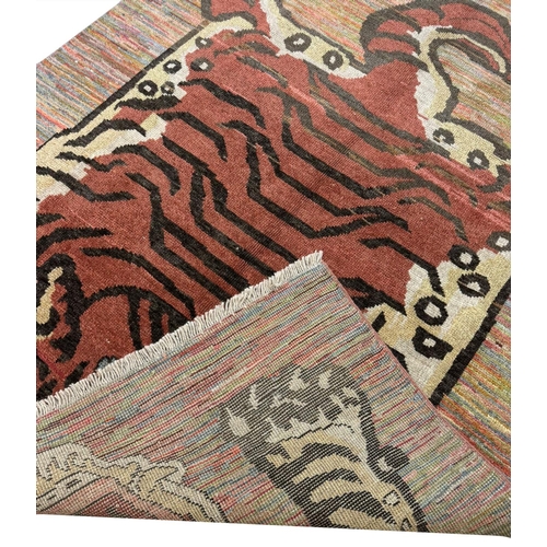 254 - FINE TIBETAN TIGER CARPET, 227cm x 173cm.