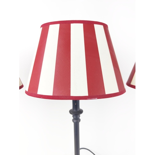 380 - TABLE LAMPS, three, with metal columns, and red and white shades, each overall 67cm tall. (3)