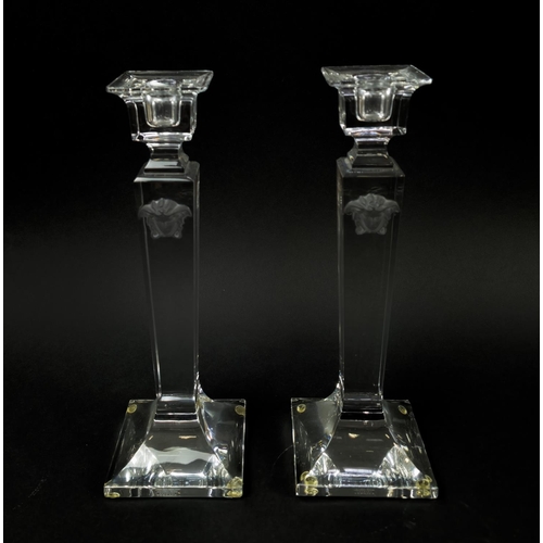 72 - VERSACE ROSENTHAL GLASS CANDLESTICKS, a pair, square form, signed to bases, 25cm H. (2)