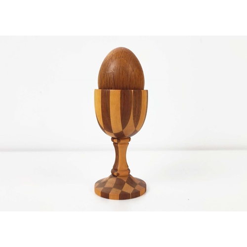 85 - A LINLEY PARQUETRY TURNED EGG CUP, pedestal base, complete with oak egg, 10cm high, stamped to under... 