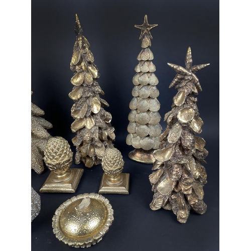 94 - ORNAMENTAL GILT CHRISTMAS DECORATIONS, comprising seven trees, two acorn finials, a lidded dish and ... 