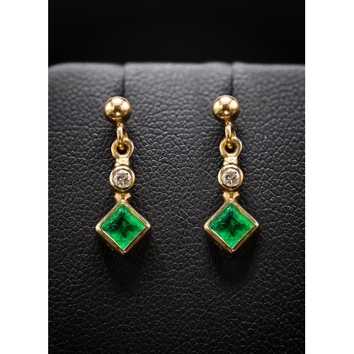 128 - A PAIR OF 9CT GOLD EMERALD AND DIAMOND DROP EARRINGS, each with a square cut emerald individually mo... 