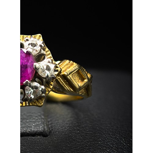 130 - AN 18CT YELLOW GOLD RUBY AND DIAMOND DRESS RING, the oval mixed cut ruby surrounded by six round bri... 