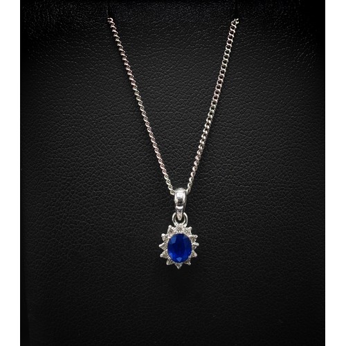 143 - 9CT WHITE GOLD SAPPHIRE AND DIAMOND SET PENDANT NECKLACE, the mixed cut sapphire surrounded by round... 