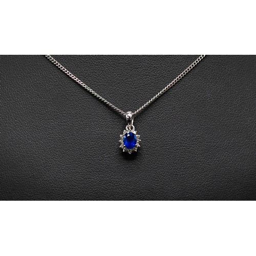 143 - 9CT WHITE GOLD SAPPHIRE AND DIAMOND SET PENDANT NECKLACE, the mixed cut sapphire surrounded by round... 