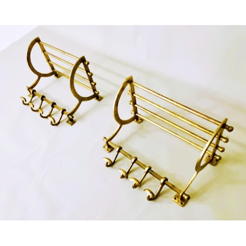 509 - LUGGAGE RACKS, a pair, gilt metal, each with four hangers, 35cm H x 46cm W x 27cm. (2)