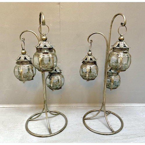 513 - LANTERNS ON STANDS, a pair, silvered metal, 75cm H x 34cm W x 30cm D. (2)