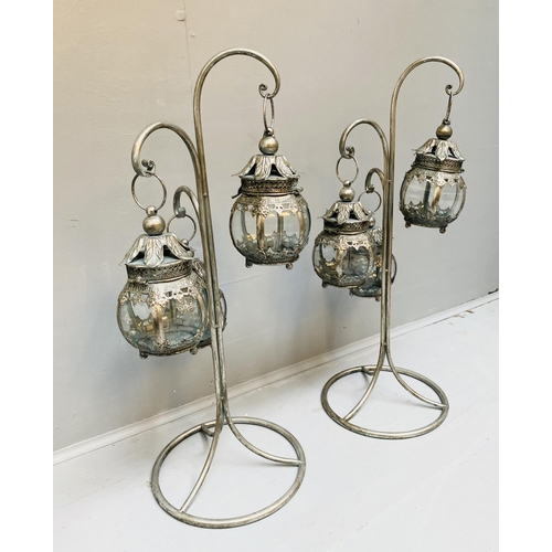 513 - LANTERNS ON STANDS, a pair, silvered metal, 75cm H x 34cm W x 30cm D. (2)