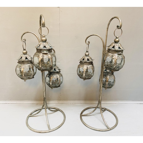 513 - LANTERNS ON STANDS, a pair, silvered metal, 75cm H x 34cm W x 30cm D. (2)