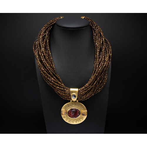 43 - CHANEL CHOKER, multi rows of iridescent bronze beads, the centre features a large gilt metal Byzanti... 