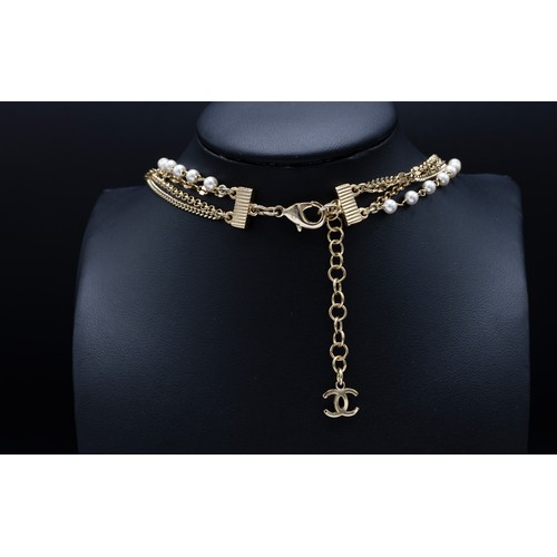 44 - CHANEL NECKLACE, four rows gold tone chain, with pearl beads and different tones of pink CC charms a... 