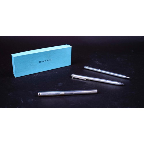 53 - TIFFANY AND CO STERLING SILVER PENS, three, with pouch and box.