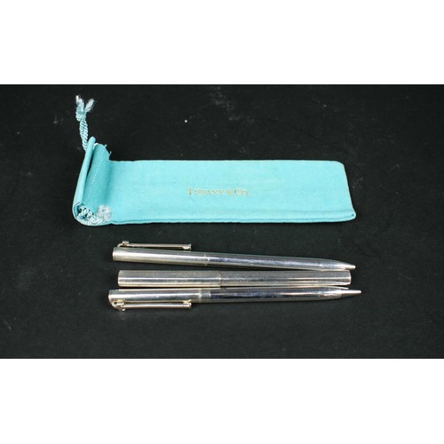 53 - TIFFANY AND CO STERLING SILVER PENS, three, with pouch and box.