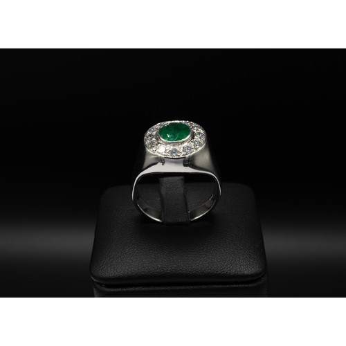 101 - AN 18CT WHITE GOLD EMERALD AND DIAMOND DINNER RING, the oval emerald of 1.70ct, surrounded by twelve... 