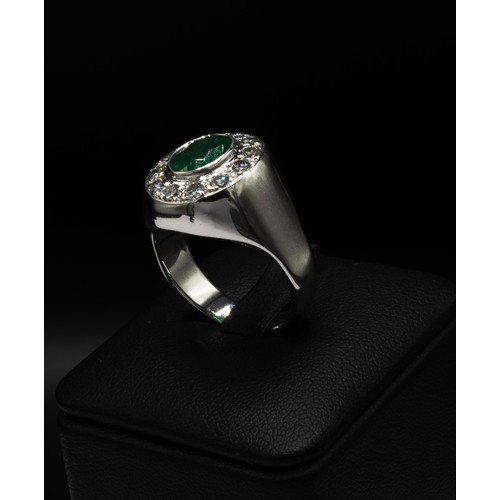 101 - AN 18CT WHITE GOLD EMERALD AND DIAMOND DINNER RING, the oval emerald of 1.70ct, surrounded by twelve... 