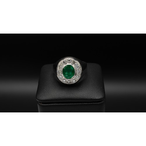 101 - AN 18CT WHITE GOLD EMERALD AND DIAMOND DINNER RING, the oval emerald of 1.70ct, surrounded by twelve... 