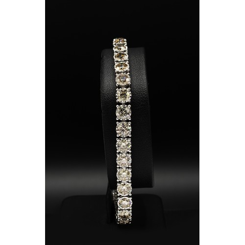 106 - A DIAMOND SET TENNIS BRACELET, encrusted with 35 round brilliant cut diamonds, with a total weight o... 