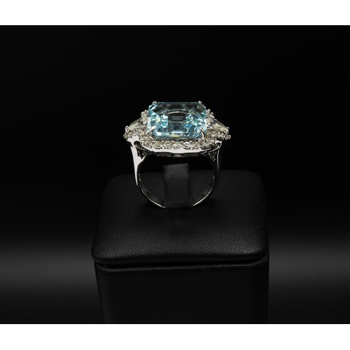 107 - AN 18CT WHITE GOLD AQUAMARINE AND DIAMOND DRESS RING, set with a large octagonal aquamarine, surroun... 