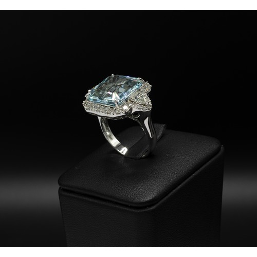 107 - AN 18CT WHITE GOLD AQUAMARINE AND DIAMOND DRESS RING, set with a large octagonal aquamarine, surroun... 