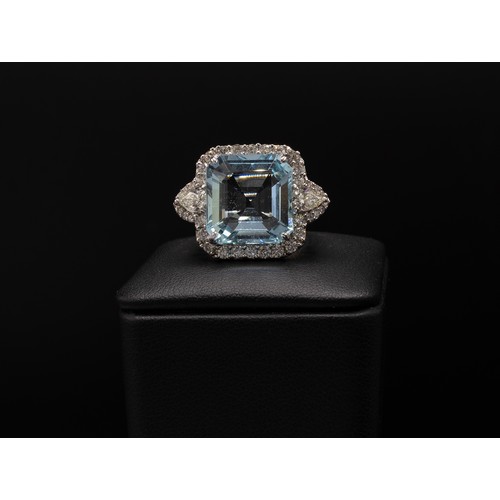 107 - AN 18CT WHITE GOLD AQUAMARINE AND DIAMOND DRESS RING, set with a large octagonal aquamarine, surroun... 