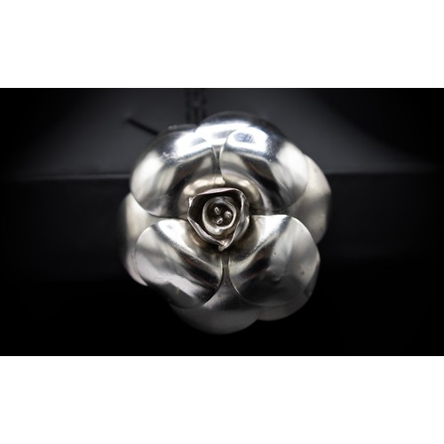 20A - CHANEL BROOCH, iconic camellia flower in silver tone metal, with safety pin closure, 5.5cm diam with... 