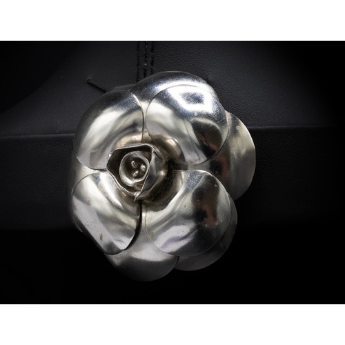 20A - CHANEL BROOCH, iconic camellia flower in silver tone metal, with safety pin closure, 5.5cm diam with... 