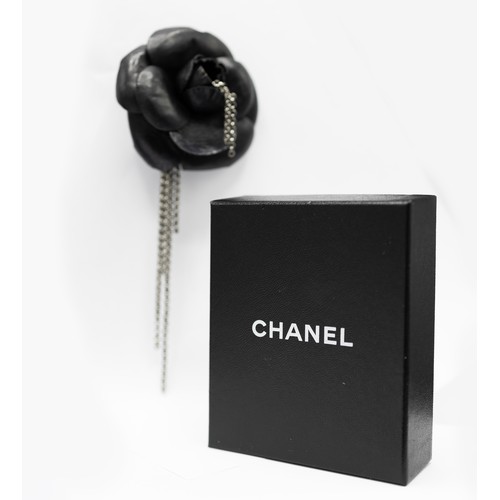 25A - CHANEL BROOCH, iconic camellia flower in black distressed calfskin leather and gun metal tone accent... 