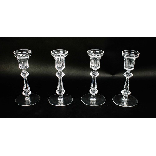 91 - A WATERFORD SET OF FOUR CANDLESTICKS, facetted stems, circular bases, each measuring 21cm high. (4)