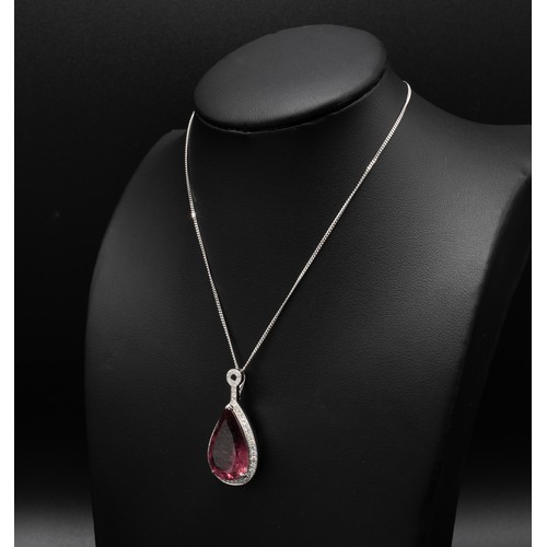 110 - AN 18CT WHITE GOLD PENDANT, set with a large pear-shaped pink tourmaline, surrounded by a halo of ro... 