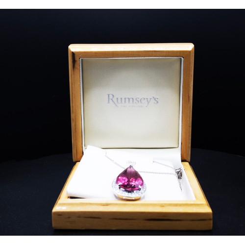 110 - AN 18CT WHITE GOLD PENDANT, set with a large pear-shaped pink tourmaline, surrounded by a halo of ro... 