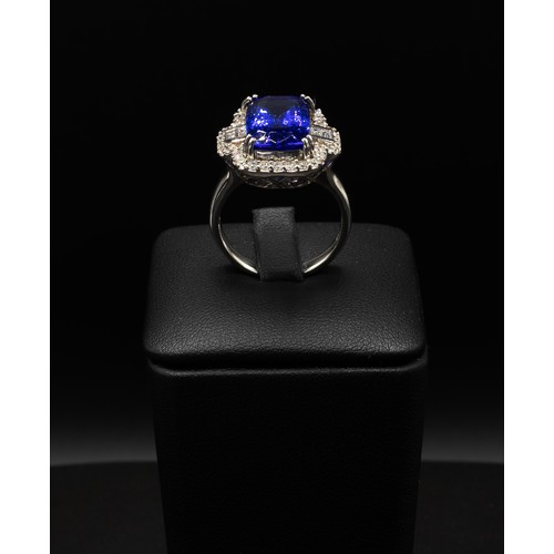 111 - AN 18CT WHITE GOLD TANZANITE AND DIAMOND DRESS RING, the central rectangular tanzanite surrounded by... 