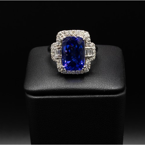 111 - AN 18CT WHITE GOLD TANZANITE AND DIAMOND DRESS RING, the central rectangular tanzanite surrounded by... 