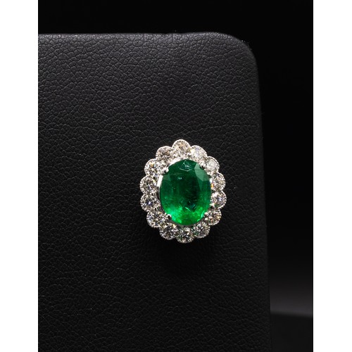 112 - A PAIR OF 18CT WHITE GOLD EMERALD AND DIAMOND STUD EARRINGS, each set with an oval mixed cut emerald... 