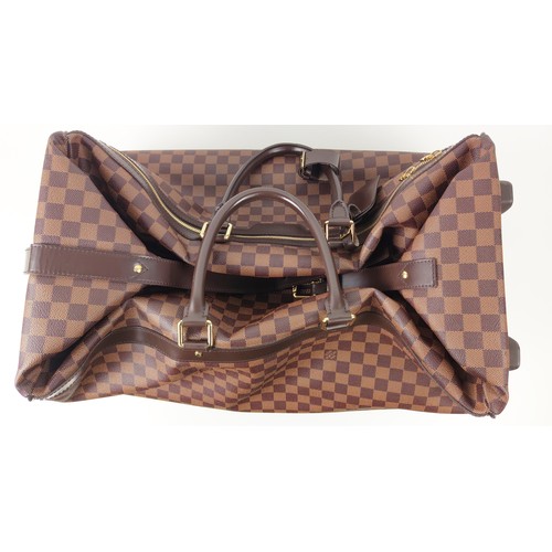 35A - LOUIS VUITTON EOLE ROLLING DUFFLE BAG, damier ebene coated canvas with fabric lining, top handles an... 