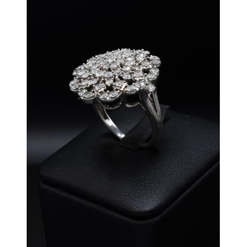 116 - A DIAMOND CLUSTER COCKTAIL RING, with an intertwined design of approximately 61 round brilliant cut ... 