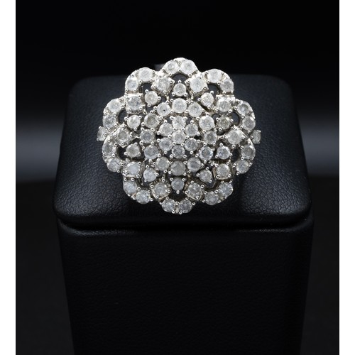 116 - A DIAMOND CLUSTER COCKTAIL RING, with an intertwined design of approximately 61 round brilliant cut ... 