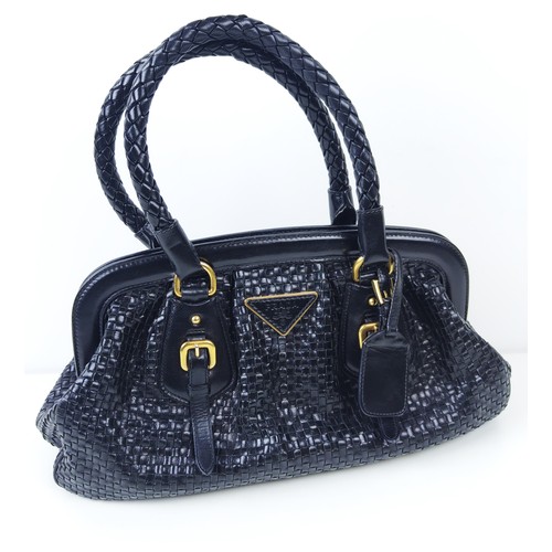 43A - PRADA HANDBAG, black weaved leather, gold tone hardware and bottom feet, two top handles, name tag, ... 