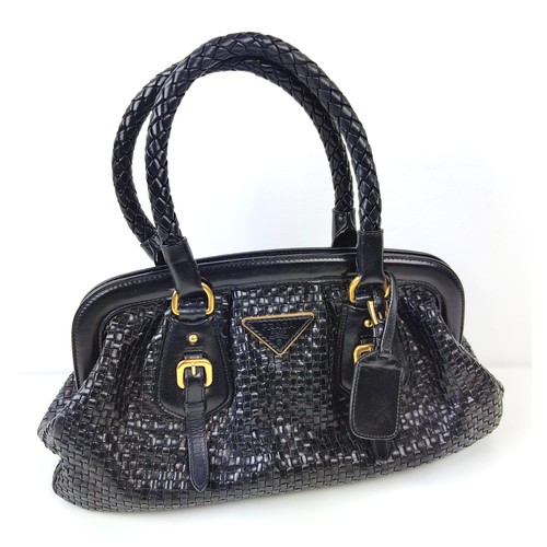 43A - PRADA HANDBAG, black weaved leather, gold tone hardware and bottom feet, two top handles, name tag, ... 