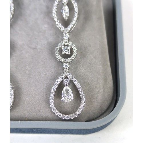 125A - A PAIR OF DIAMOND ENCRUSTED WHITE METAL PENDANT EARRINGS, possibly 18ct white gold, set with marquis... 