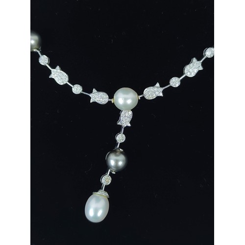 130A - A DIAMOND ENCRUSTED WHITE METAL AND PEARL NECKLACE, possibly 18ct white gold, with white and Tahitia... 