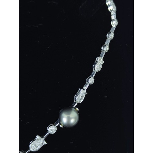 130A - A DIAMOND ENCRUSTED WHITE METAL AND PEARL NECKLACE, possibly 18ct white gold, with white and Tahitia... 