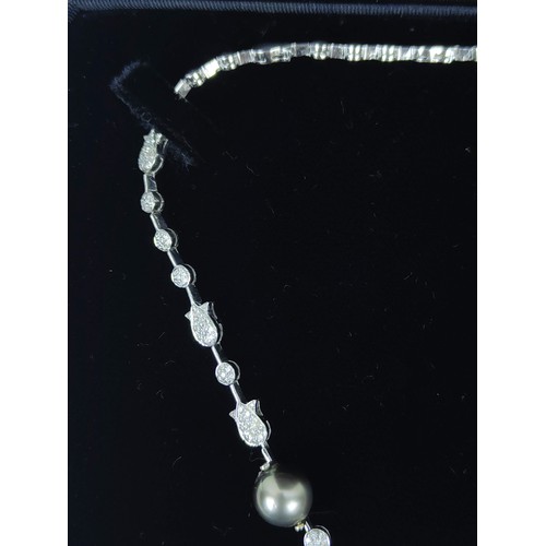 130A - A DIAMOND ENCRUSTED WHITE METAL AND PEARL NECKLACE, possibly 18ct white gold, with white and Tahitia... 