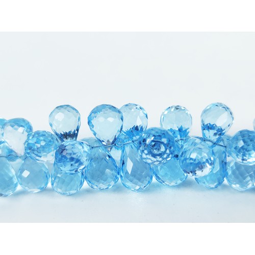 110A - A TOPAZ SINGLE STRAND FACETED BEAD NECKLACE, the Swiss blue topaz stones of pear shape and multiface... 