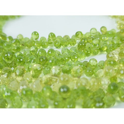 115A - A PERIDOT FIVE STRAND FACETED BEAD NECKLACE, the peridot stones of pear shape and multifaceted, fitt... 