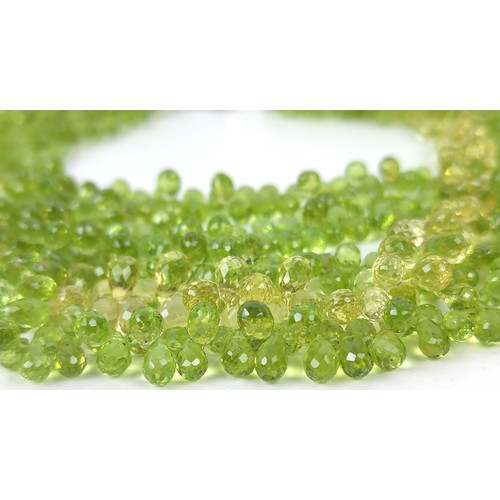 115A - A PERIDOT FIVE STRAND FACETED BEAD NECKLACE, the peridot stones of pear shape and multifaceted, fitt... 