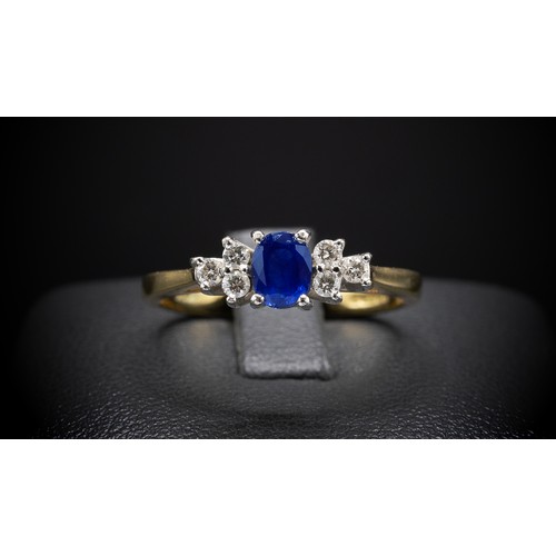 137 - AN 18CT YELLOW GOLD SAPPHIRE AND DIAMOND DRESS RING, the central oval mixed cut sapphire flanked by ... 