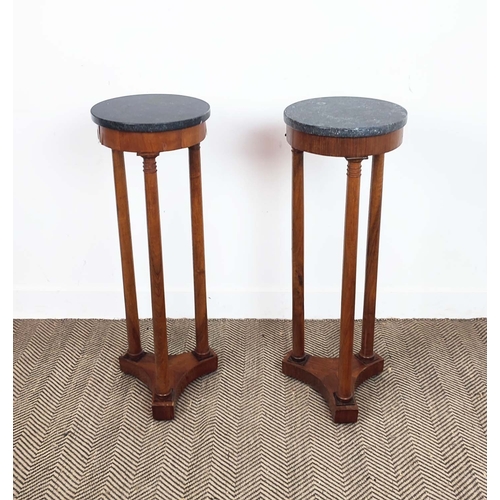 151 - GUERIDONS, a pair, 19th century Empire revival, each with a black circular marble top, each 90cm H x... 