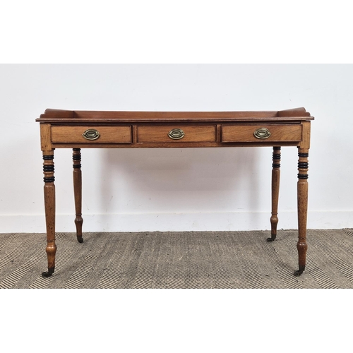 145 - WRITING TABLE, George IV mahogany and ebonised with three quarter gallery top over three frieze draw... 