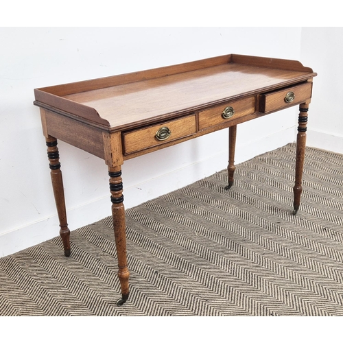 145 - WRITING TABLE, George IV mahogany and ebonised with three quarter gallery top over three frieze draw... 